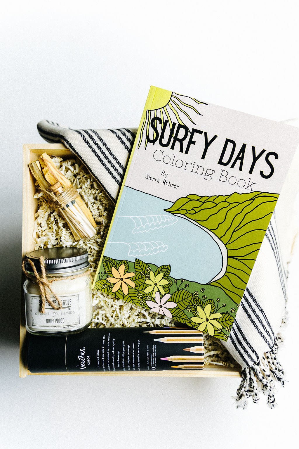 Surfside Sketch Gift box with 'Surfy Days' coloring book, 24 colored pencils, candle, and towel on a white background