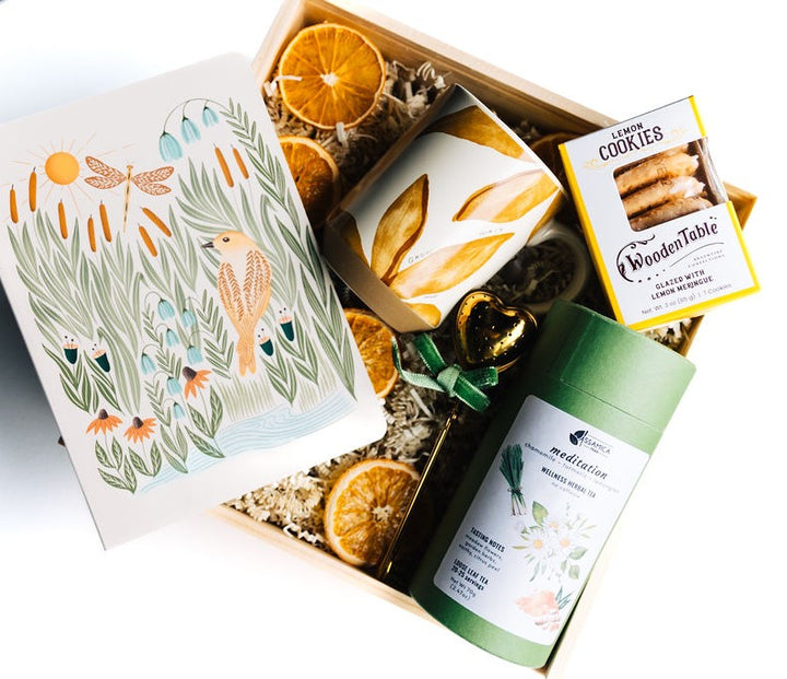 Relaxation tea gift box with heart tea infuser, herbal tea, cookies, and ceramic mug in wooden box with dried oranges