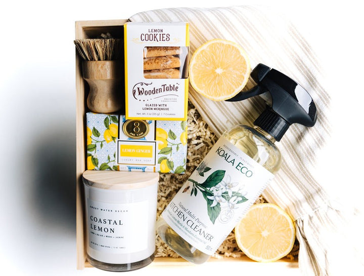 Luxury Home Sweet Home Gift Box with lemon candle, ruffle towel, cleaner, cookies, and eco brush in a wooden keepsake box