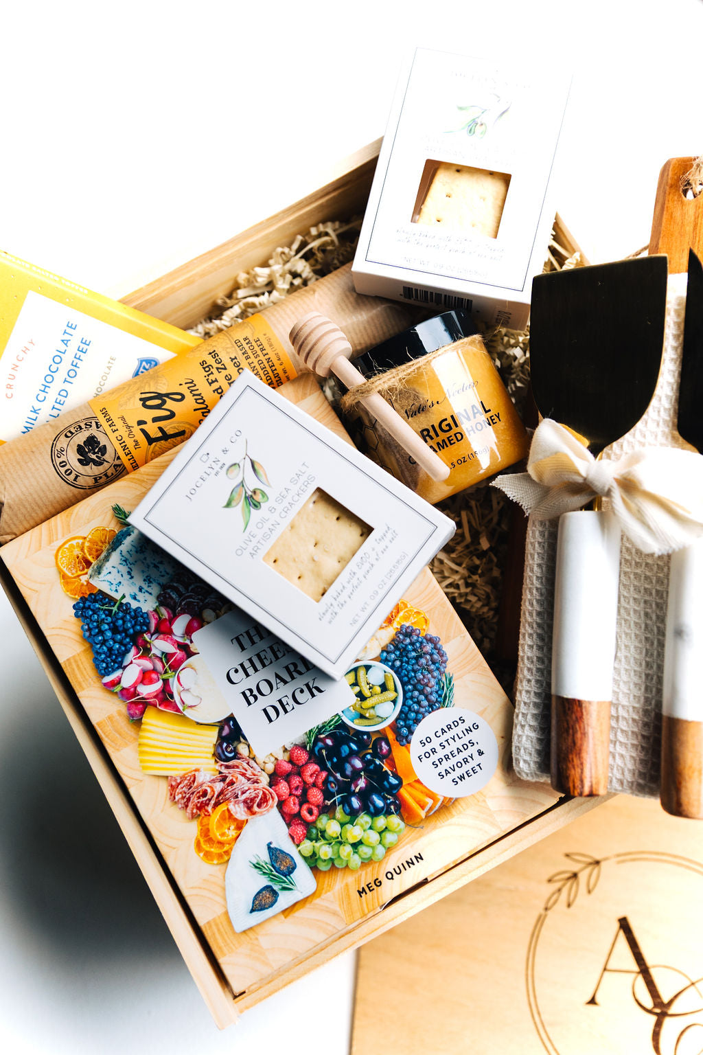 Luxury wooden gift box filled with gourmet treats and hosting essentials