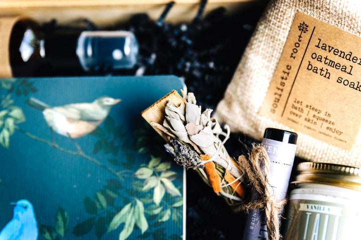 Close-up of lavender oatmeal bath soak, pillow spray, and lavender tallow lip balm in a calming self-care gift set