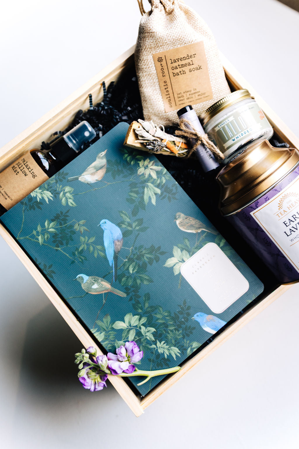 Flat-lay of Lavender Dusk Gift Box featuring Earl of Lavender tea, lavender bath soak, and Midnight Bird journal