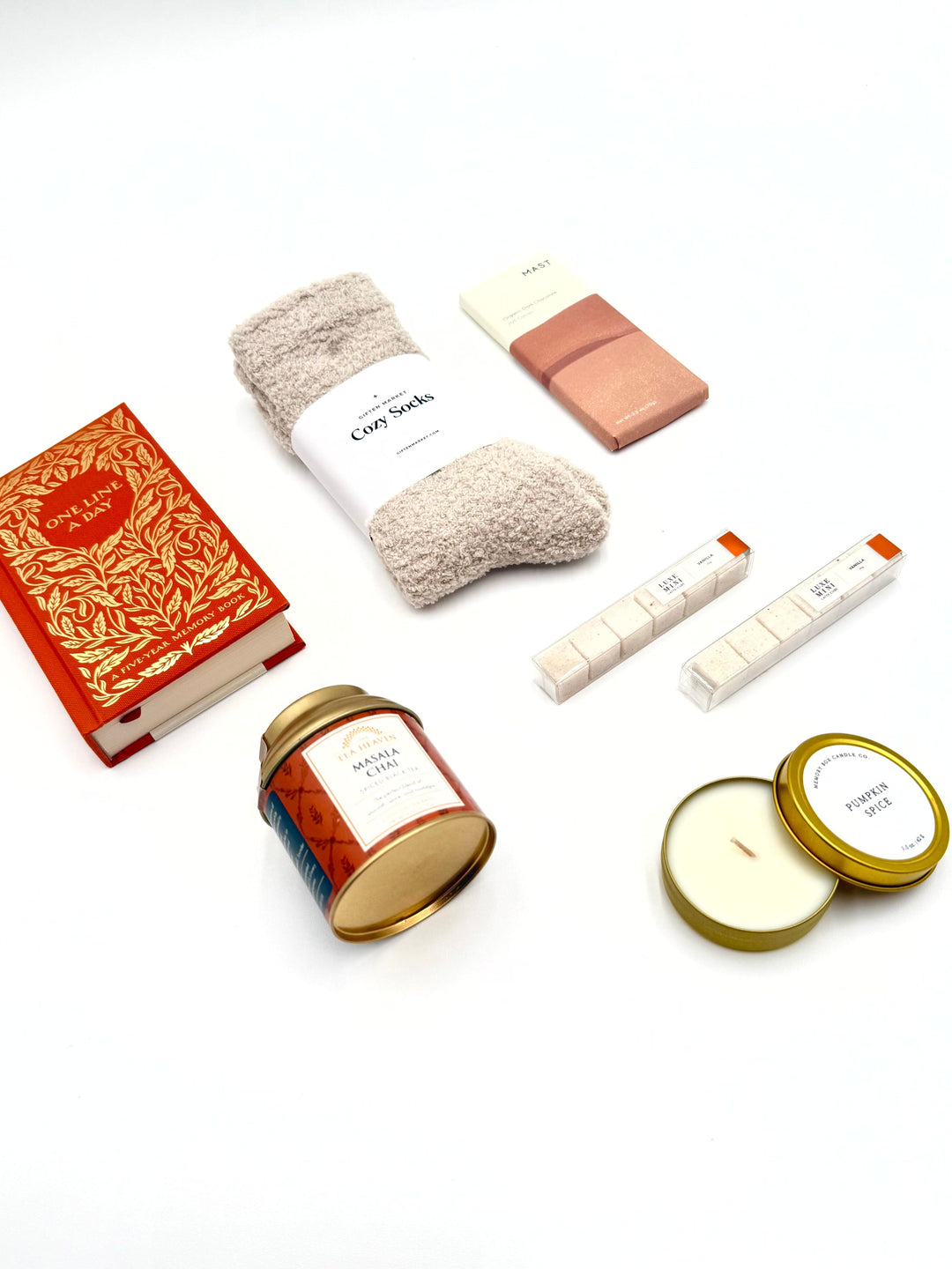 Flat lay of The Autumn Edit Gift Box contents styled with warm autumn accents