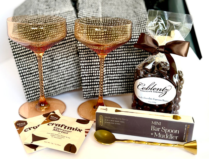 Elegant gift box for cocktail lovers with amber glass coupes and bar accessories
