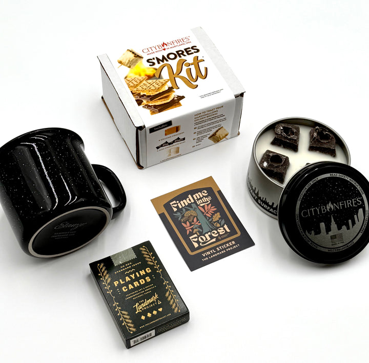 Includes mug, s’mores kit, City Bonfires fire pit, playing cards, and sticker, all displayed on white background