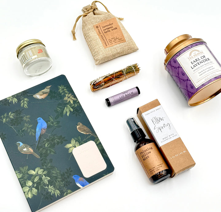 Unboxed contents of Lavender Dusk Relaxation Gift Set including lavender tea, bath soak, pillow mist, journal, and moisturizer