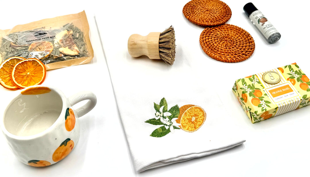 Flat lay of A Hint of Orange Gift Box contents styled with citrus and natural textures