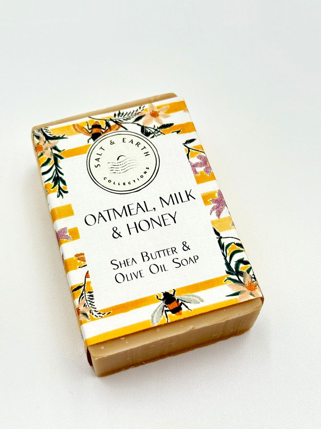 Artisan soap with shea butter and olive oil in yellow floral bee-themed packaging