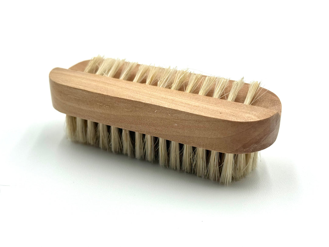 Natural wood nail brush with firm bristles, perfect for cleaning hands after gardening
