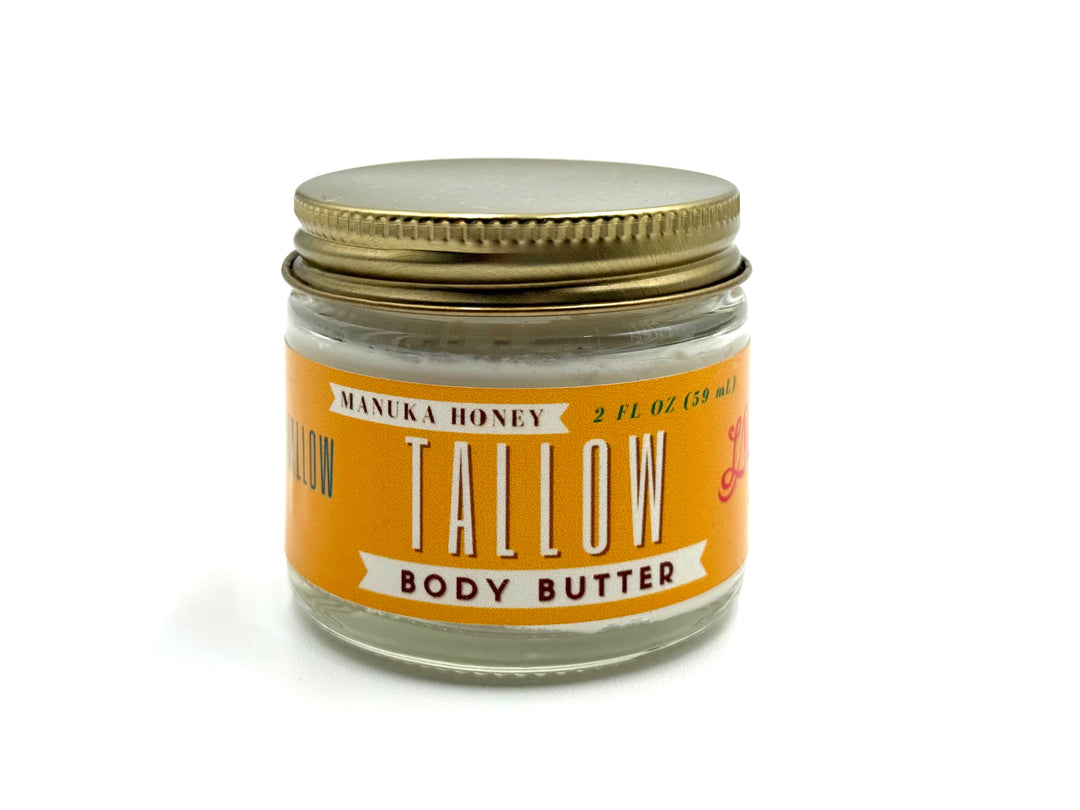 Whipped tallow moisturizer in amber jar with gold lid, labeled Manuka Honey & Rosehip