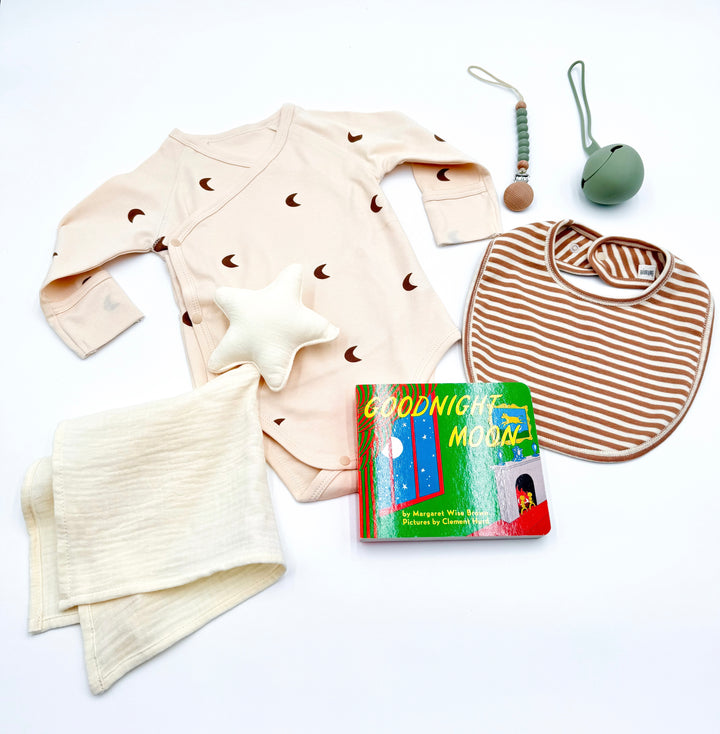 Flat lay of newborn gift products in Love you to the moon gift box